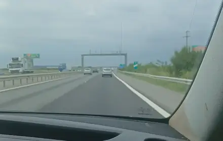 The A1 motorway between Bucharest and Craiova seen from the front of a minivan — the last leg of the overland route from Banja Luka
