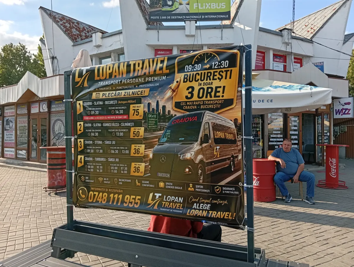 Lopan Travel timetable board at the North Bus Station in Craiova: routes to București, Călimănești and Târgu Jiu with departure times and fares in lei, the station building behind, 13 August 2026