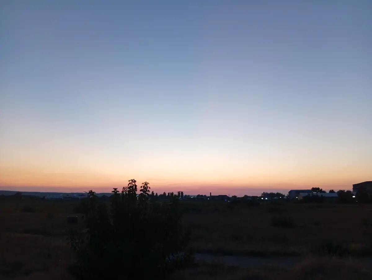 Sunset over the open fields by Craiovița Nouă, Craiova, a young tree in silhouette in front, 20 September 2026