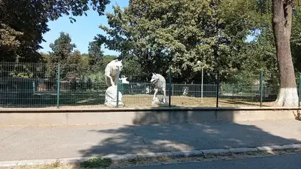 Wolf sculptures at the fence of Zoo Craiova, inside Nicolae Romanescu Park