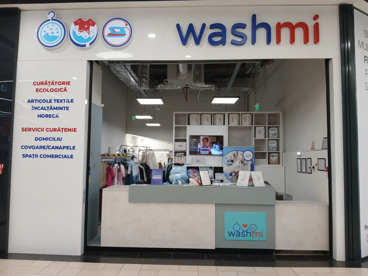 The Washmi unit inside Promenada Mall — walk-in counter, garment rail behind it. September 2026