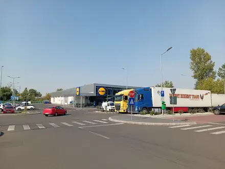 Lidl across the shared forecourt, artics parked along the lorry bays