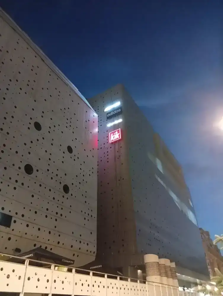 The perforated towers from the terrace side, signs lit