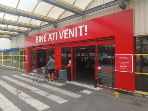 The entrance of Selgros Craiova under the red Bine ati venit sign, with the opening hours posted beside the doors