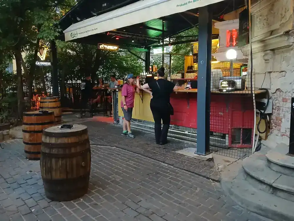 The bar built into the corner of the yard, barrels out front