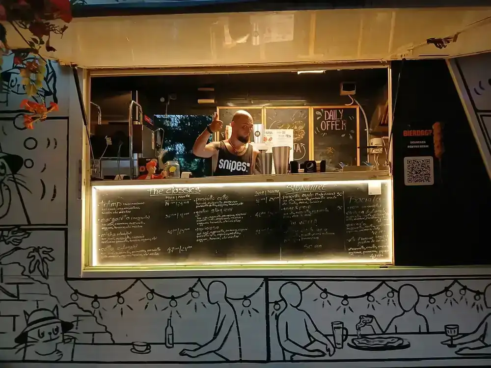 The pizza hatch and its chalkboard — a snapshot of one evening, 24 August 2026, not a live menu