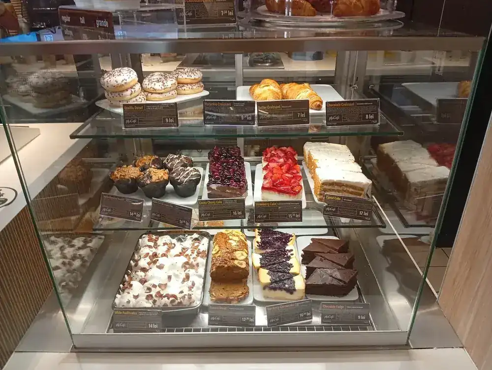 The cake case — croissants, cheesecake, carrot cake