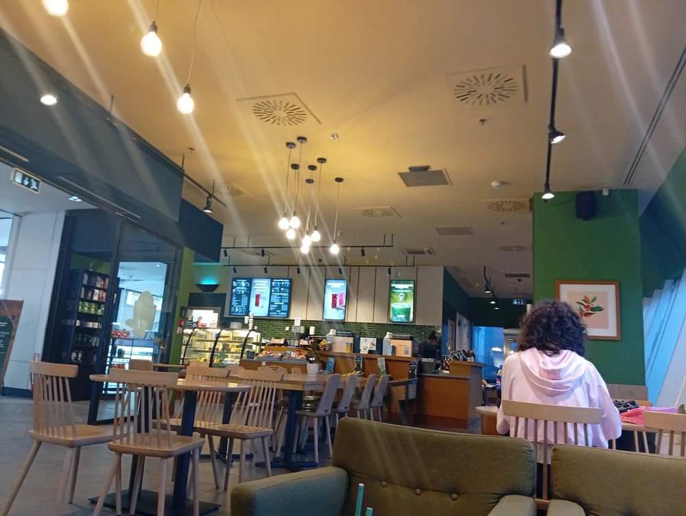 The room — tables, armchairs and the bar at the back