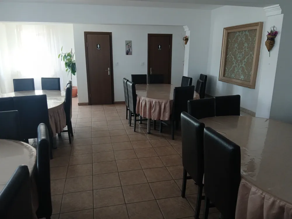 The dining room — round tables, the toilets off the far wall