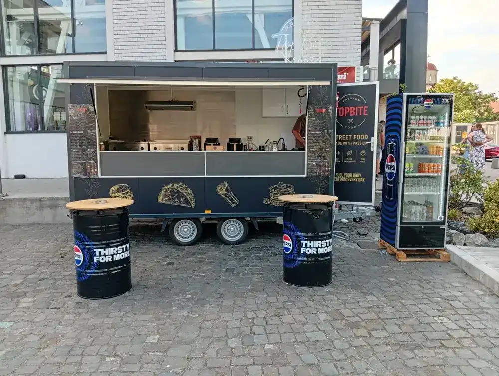 The trailer on the plaza, standing barrels out front