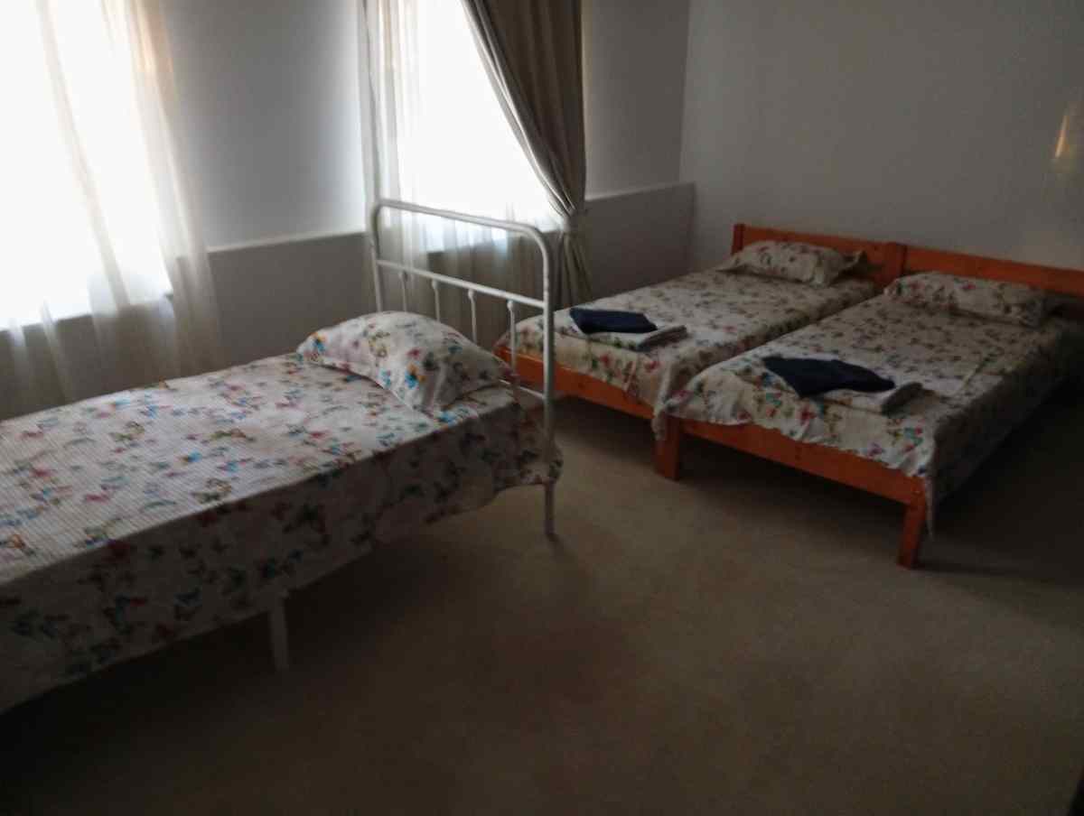 Third room, three single beds — good for a family or a crew