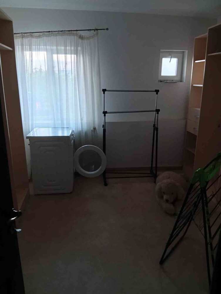 Utility room — washing machine, drying rack, storage